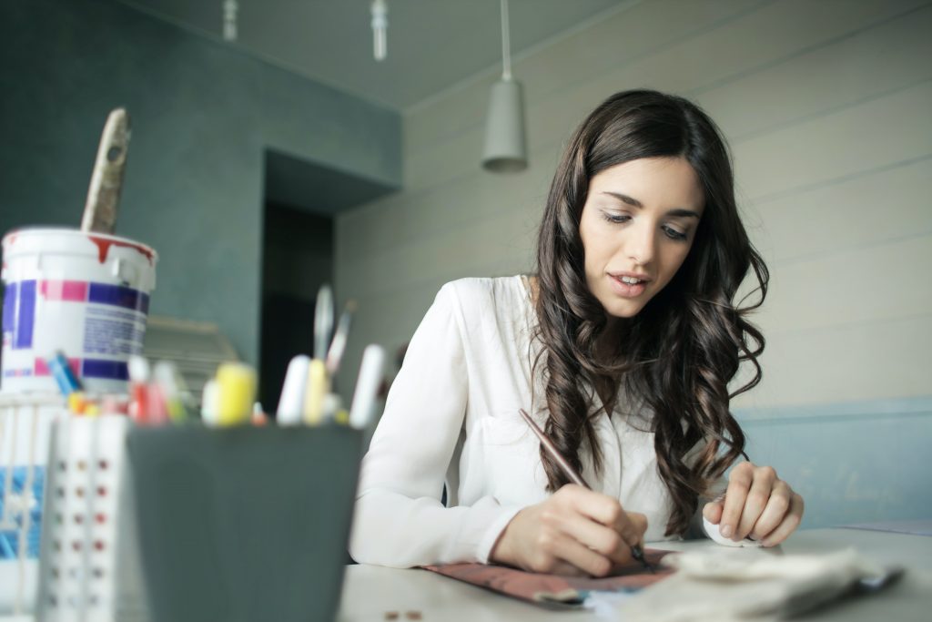 ::Downloads:woman-sitting-while-holding-pen-920377.jpg